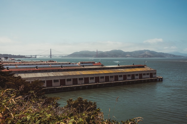 Foto grátis trem marrom e branco na ponte ferroviária sobre a água durante o dia