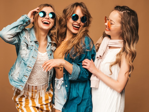Três jovens lindas meninas sorridentes em roupas casuais na moda verão. Mulheres sexy despreocupadas posando. Modelos positivos