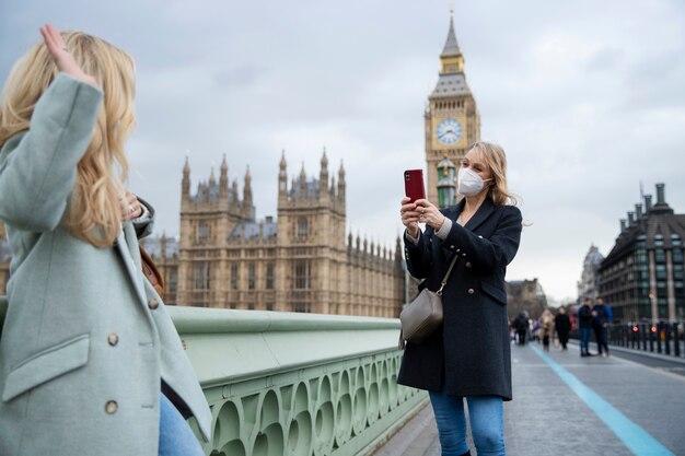 Turistas visitando a cidade e usando máscara de viagem