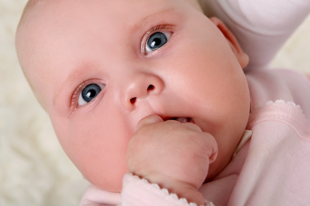 Um bebê jovem e bonito de rosa