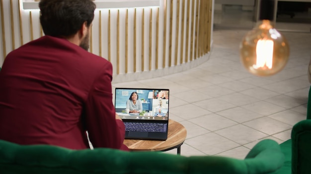 Um cavalheiro em videoconferência com clientes.