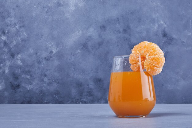 Um copo de suco de tangerina.