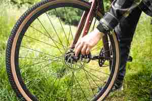 Foto grátis um homem corrige um problema com uma roda de bicicleta generativa ai