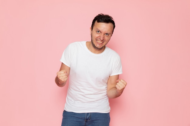 Foto grátis um jovem do sexo masculino com uma camiseta branca posando com expressão emocional