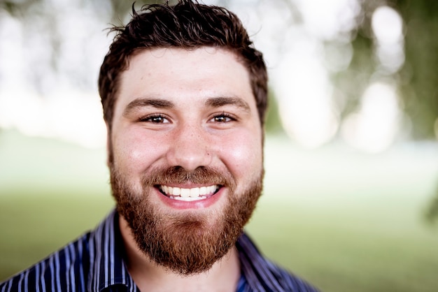 Uma foto de foco superficial de um homem branco e branco sorridente