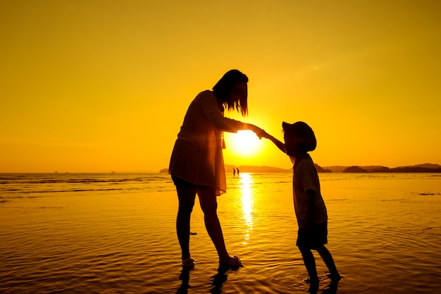 Uma mãe e filho ao ar livre ao pôr do sol com cópia espaço