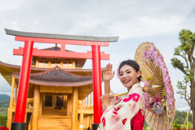 Uma mulher asiática bonita que desgasta um quimono japonês, conceito tradicional do vestido.