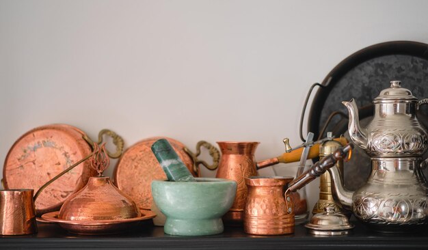 Utensílios de cobre feitos à mão Utensílios de mesa tradicionais turcos em uma prateleira na cozinha em casa foco seletivo espaço de cópia para texto