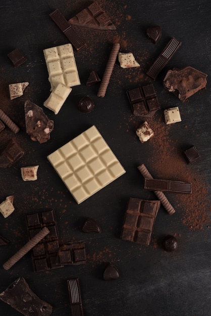 Variedade de diferentes tipos de barras de chocolate quebradas em pedaços