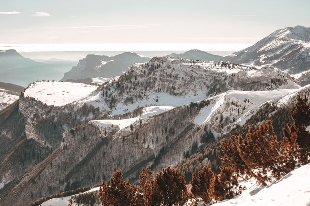 Vista aérea de montanhas cobertas de neve sob o céu azul claro