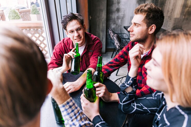Foto grátis vista alta ângulo, de, amigos, sentando, junto, desfrutando, a, cerveja