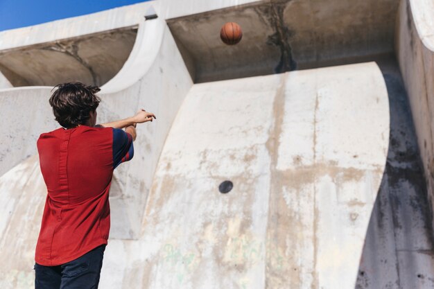 Vista baixa ângulo, de, um, menino adolescente, basquetebol jogando