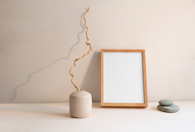 Foto grátis vista da decoração do quarto composta de moldura e vaso de plantas com pedras