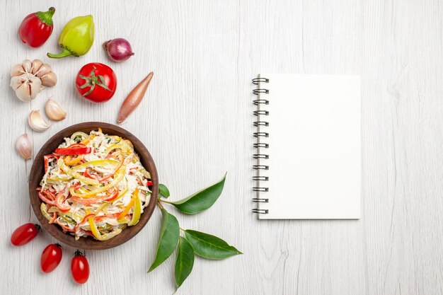 Vista de cima deliciosa salada de frango com mayyonaise e vegetais na mesa branca salgadinhos de carne madura salada de refeição fresca