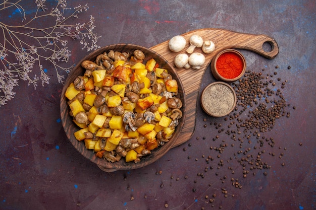 Vista de cima uma tigela com comida uma tigela com batatas com cogumelos cogumelos brancos e especiarias coloridas