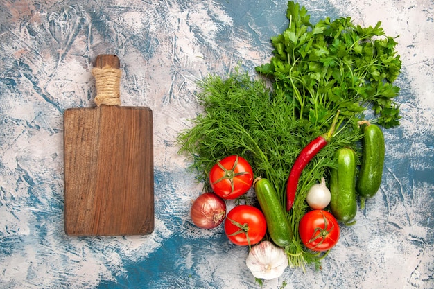 Vista de cima verduras frescas com tomates e pepinos em um fundo claro