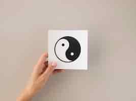 Foto grátis vista frontal da pessoa segurando o símbolo ying e yang