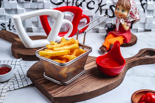 Foto grátis vista frontal de batatas fritas em uma cesta com ketchup no quadro