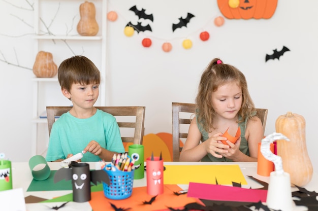 Vista frontal de crianças com arranjos do conceito de halloween