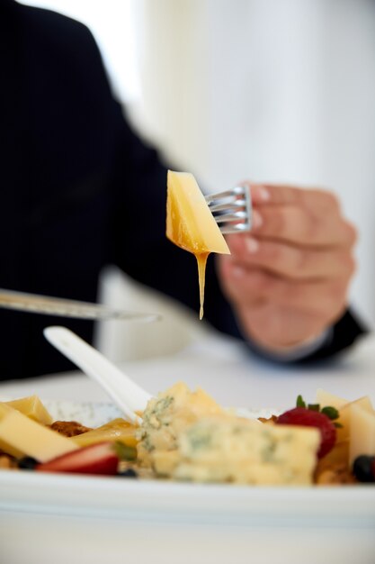 Vista frontal de um delicioso almoço de negócios, morango e saboroso queijo