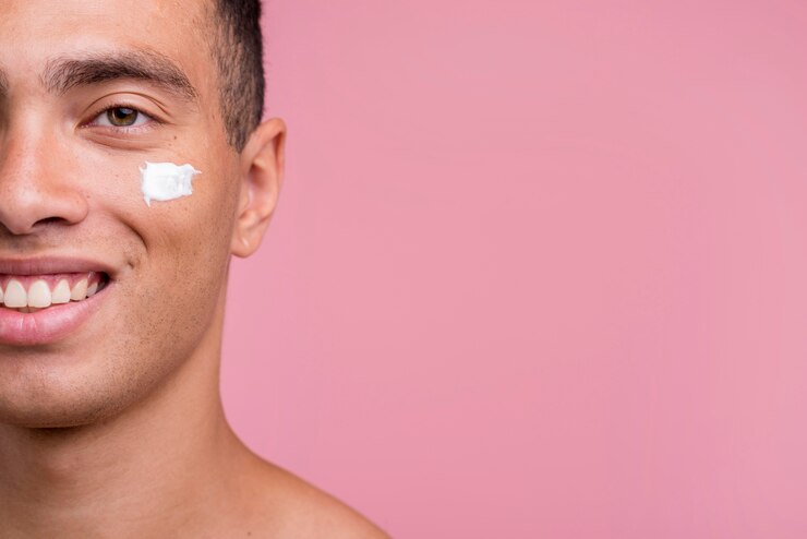 Foto grátis vista frontal de um homem sorridente com creme no rosto