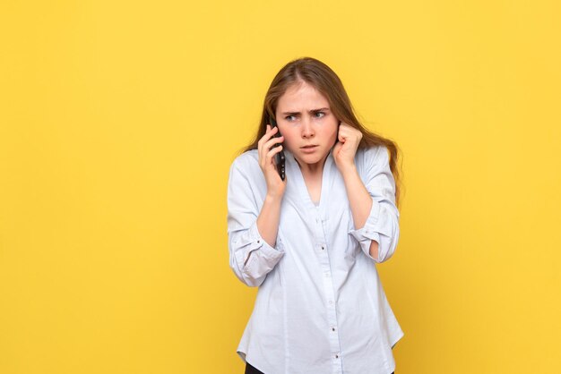 Vista frontal de uma jovem falando ao telefone