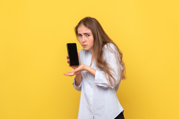 Vista frontal de uma jovem segurando um smartphone