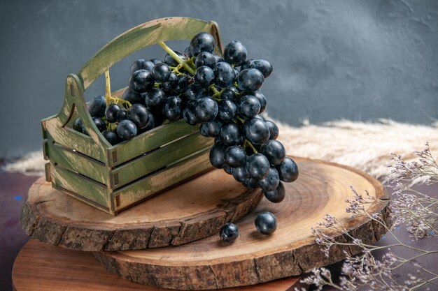 Vista frontal de uvas frescas maduras frutas escuras na superfície escura vinho uva fruta madura planta de árvore fresca