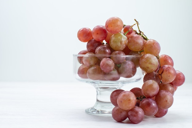 Vista frontal de uvas verdes frescas frutas ácidas e maduras na superfície branca frutas frescas vinho árvore planta suave