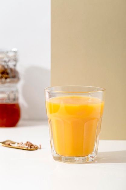 Foto grátis vista frontal delicioso smoothie de laranja em uma mesa