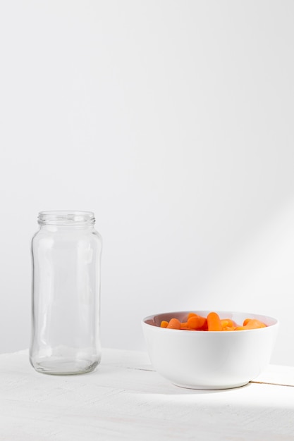 Vista frontal do frasco de vidro com cenouras infantis para conservar