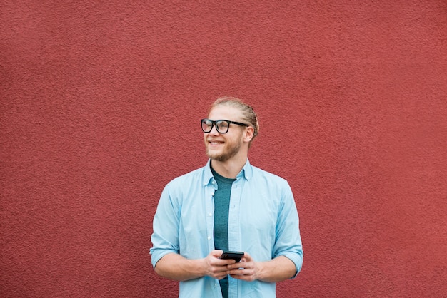 Foto grátis vista frontal do homem sorridente com cópia espaço e smartphone