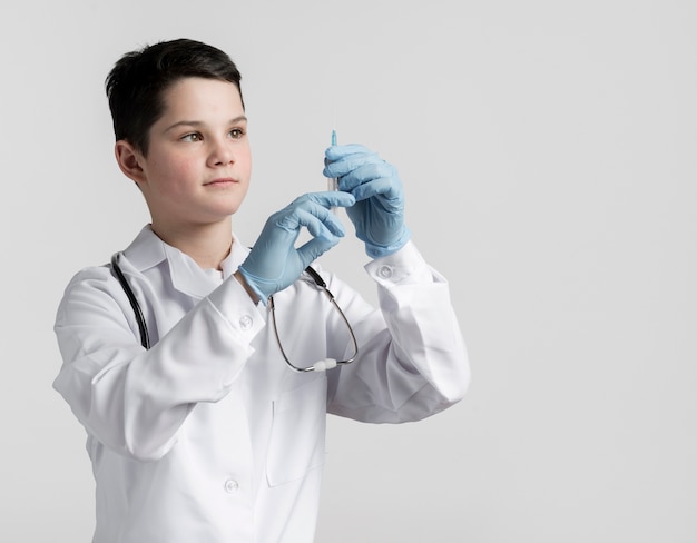 Foto grátis vista frontal jovem rapaz preparando seringa médica