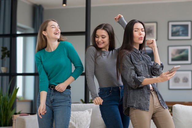 Vista frontal jovens mulheres dançando dentro de casa