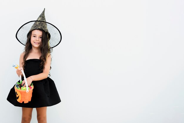Vista frontal menina fantasiada de bruxa para o halloween