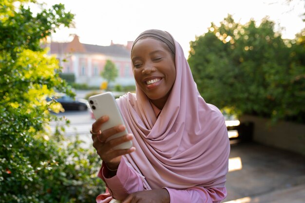 Vista frontal mulher vestindo halal ao ar livre
