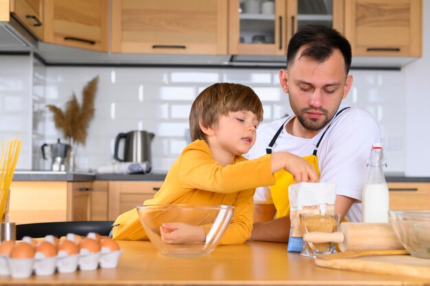 Vista frontal pai e filho pronto para cozinhar