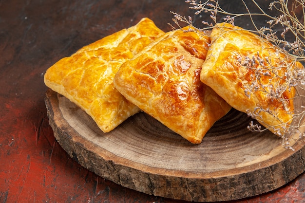 Vista inferior de penovani khachapuri na placa de madeira na mesa vermelha escura