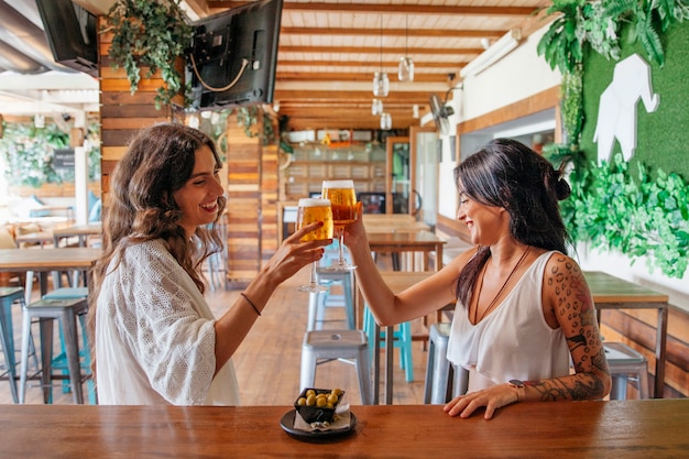 Vista lateral das mulheres com cerveja