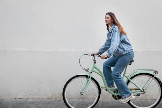 Vista lateral de mulher andando de bicicleta