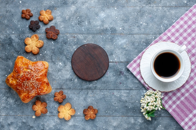 Vista superior da xícara de café junto com bolo e biscoitos deliciosos na mesa cinza, bolo de açúcar