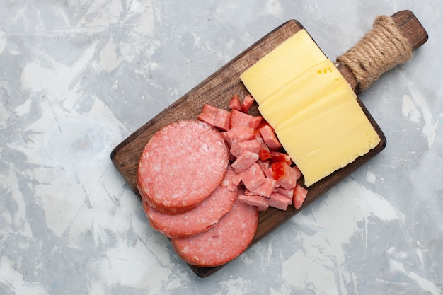 Foto grátis vista superior das salsichas fatiadas com queijo no branco