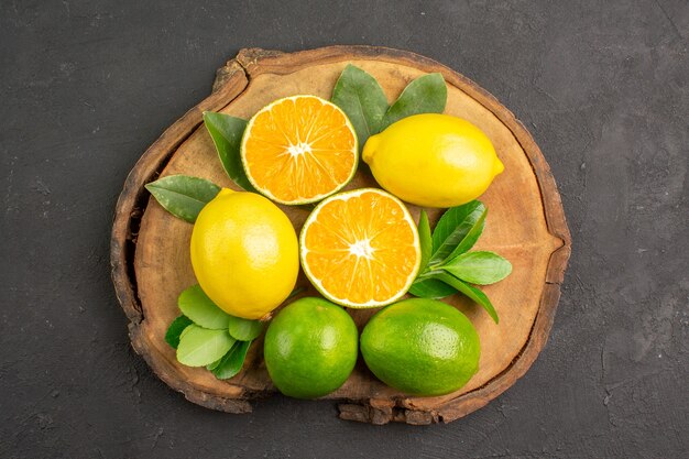 Vista superior de limões azedos frescos em frutas cítricas limão de mesa escura