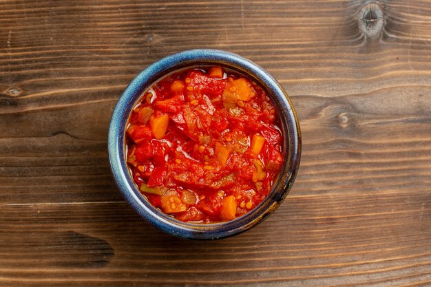 Vista superior do molho de tomate com vegetais no fundo marrom refeição molho de tomate vegetal