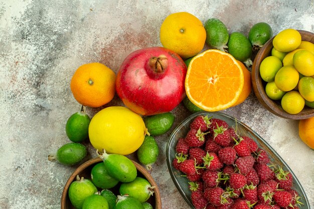 Vista superior frutas frescas diferentes frutas suaves no fundo branco saúde árvore cor saborosa foto frutas cítricas maduras
