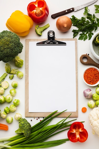 Foto grátis vista superior mistura de legumes com caderno em branco