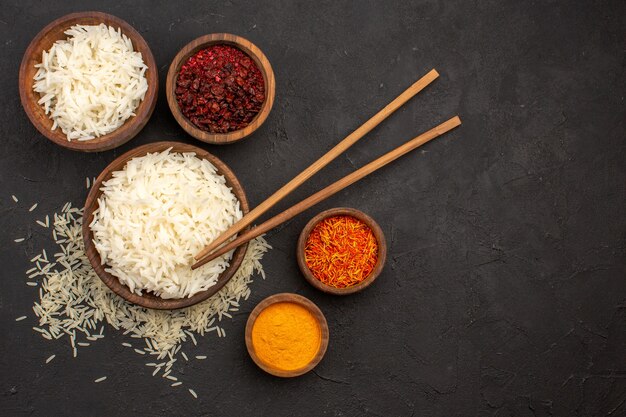 Vista superior saborosa refeição oriental saborosa de arroz cozido com temperos no escuro