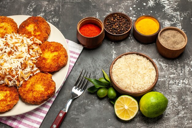 Vista superior saborosas costeletas fritas com arroz e temperos em rissole de carne de chão escuro