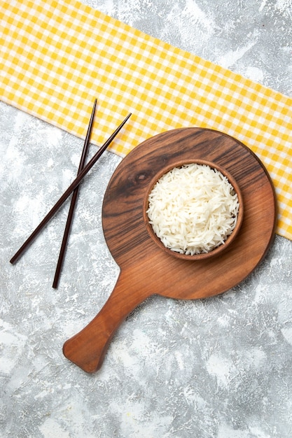 Foto grátis vista superior saboroso arroz cozido dentro de um prato marrom no branco