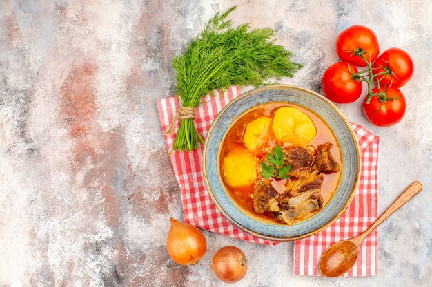 Vista superior sopa bozbash caseira toalha de cozinha um monte de endro tomates cebolas colher de pau na superfície nua